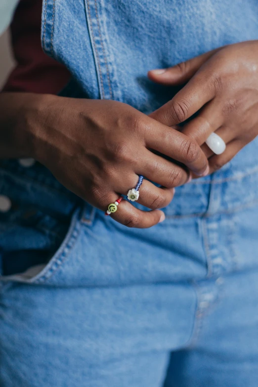 a close up of a woman's belt and jeans with a blue denim jacket