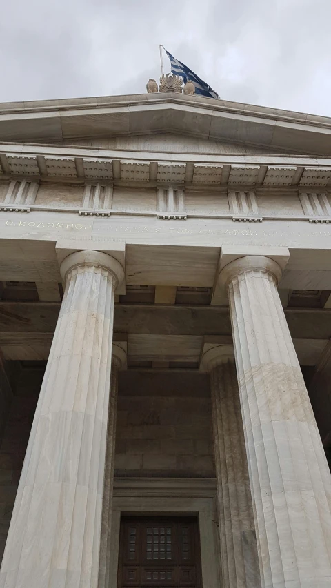 a tall stone building with columns around it