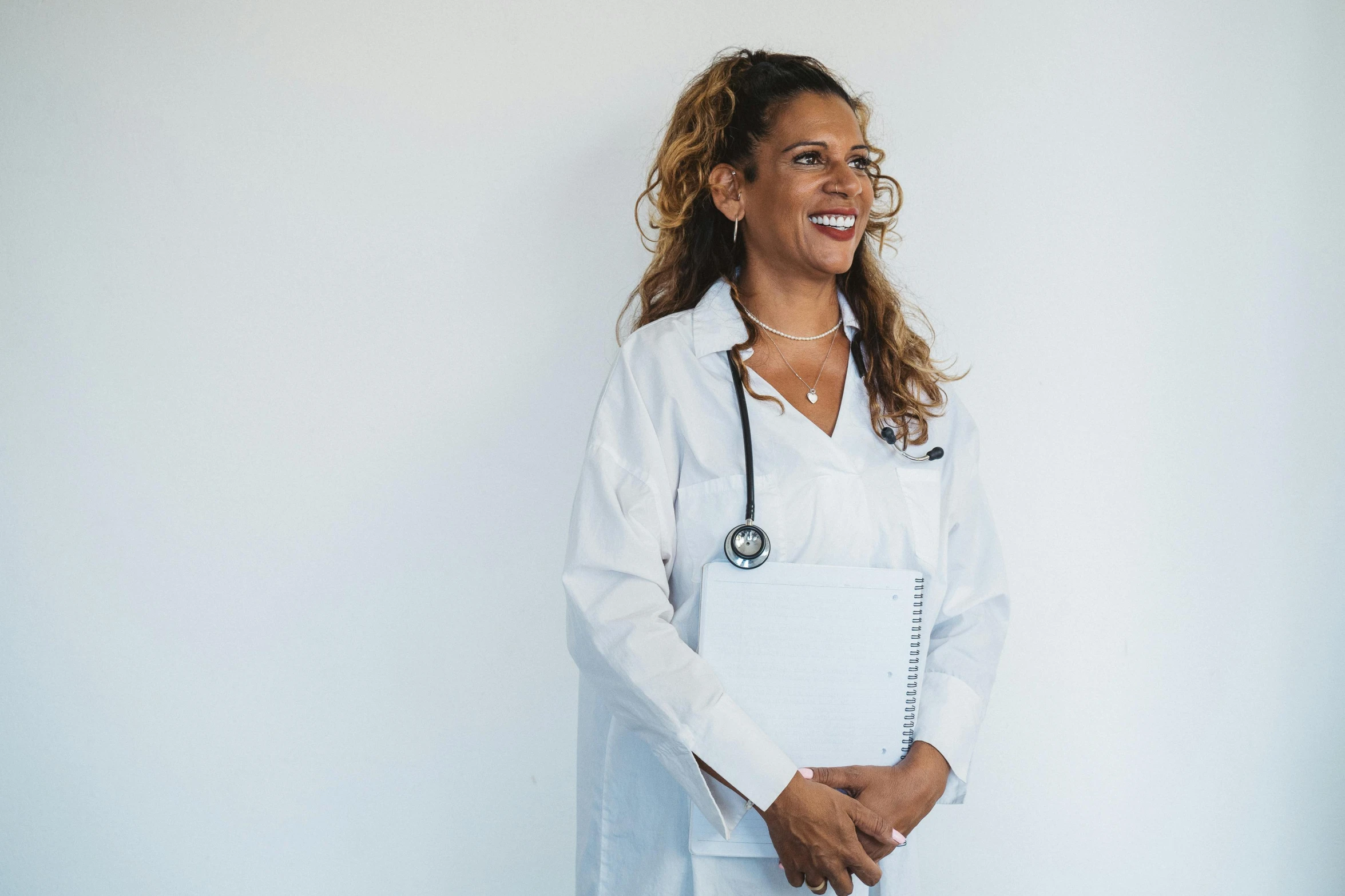 a female doctor smiling and wearing an apron