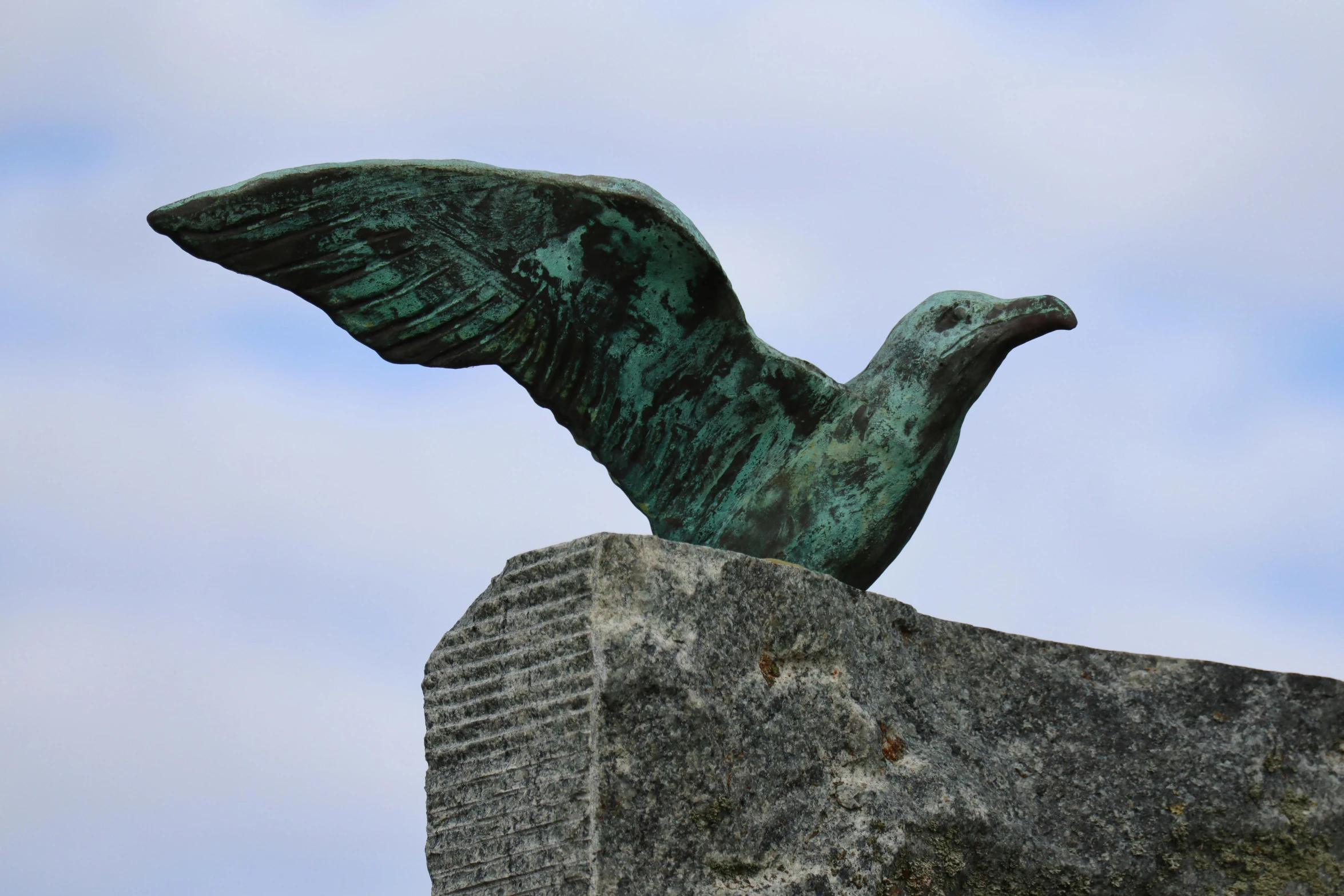 there is a statue of an eagle on top of a rock