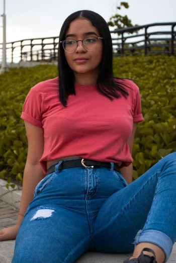 a woman in a red shirt is posing for the camera