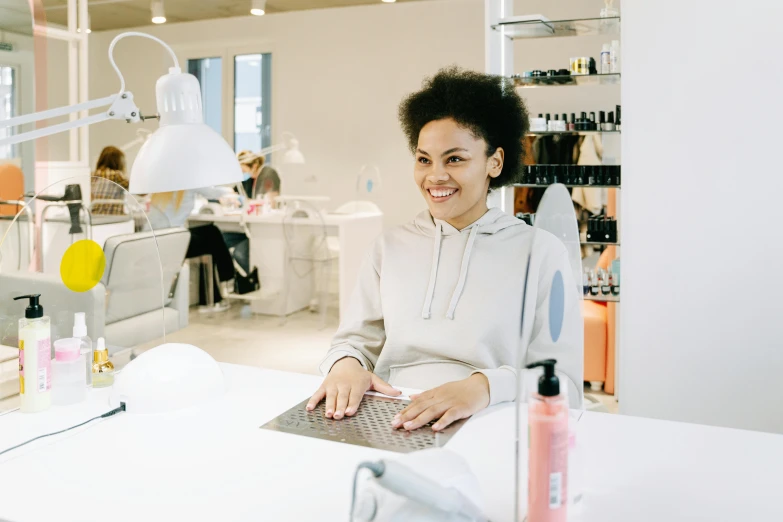 the woman smiles while she works on her product