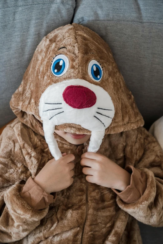 a little  wearing a costume while laying on a couch