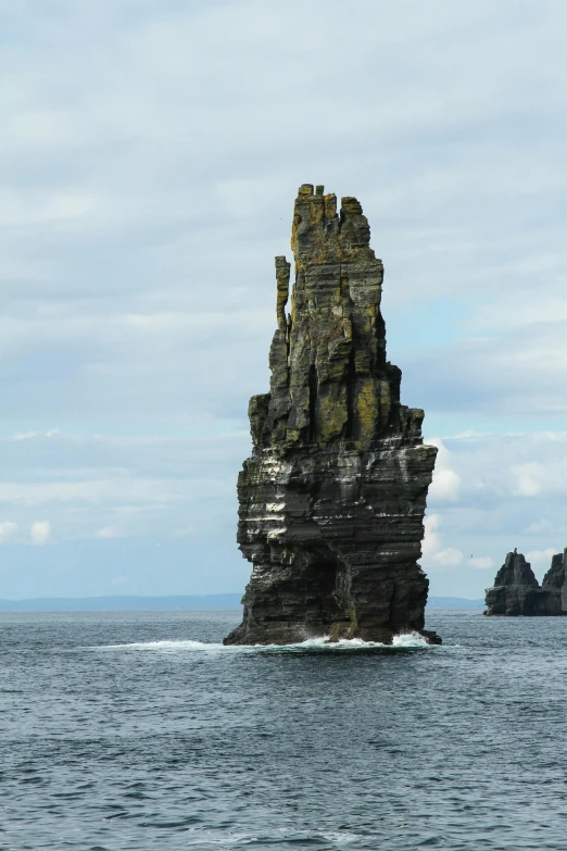 a rock formation in the middle of the ocean