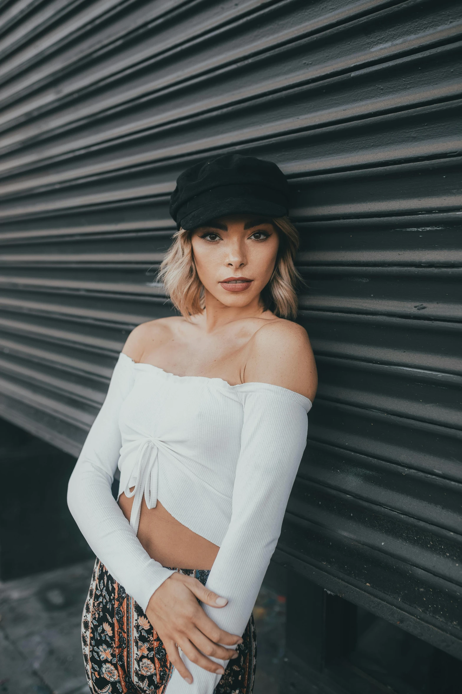 a young woman posing in front of a building