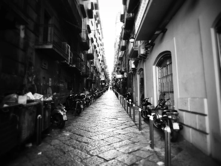 a narrow street with bikes parked on it