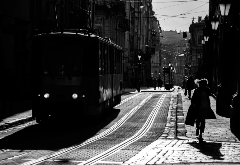 black and white image of street view with bus on road