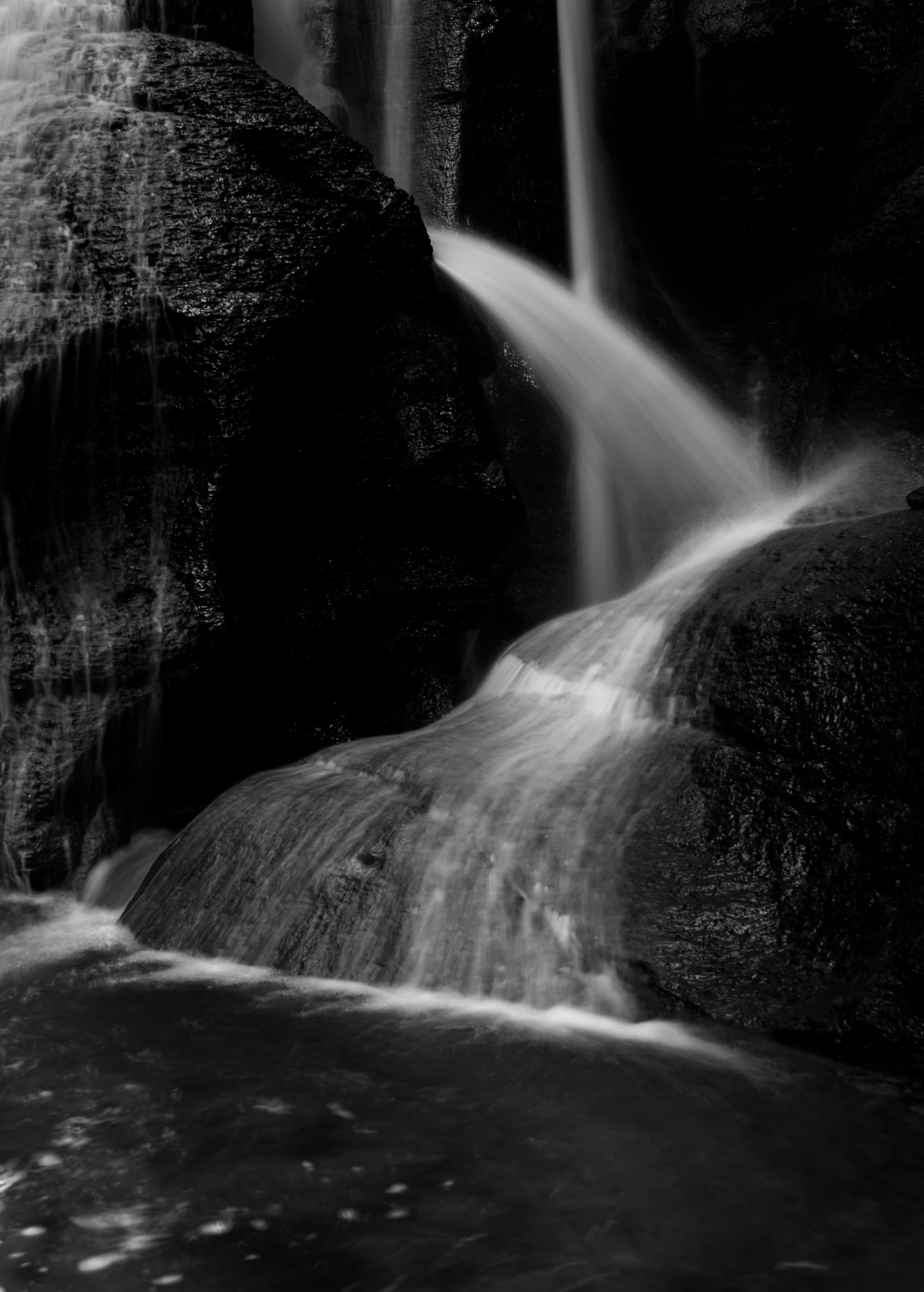 waterfall in black and white po, with a light house