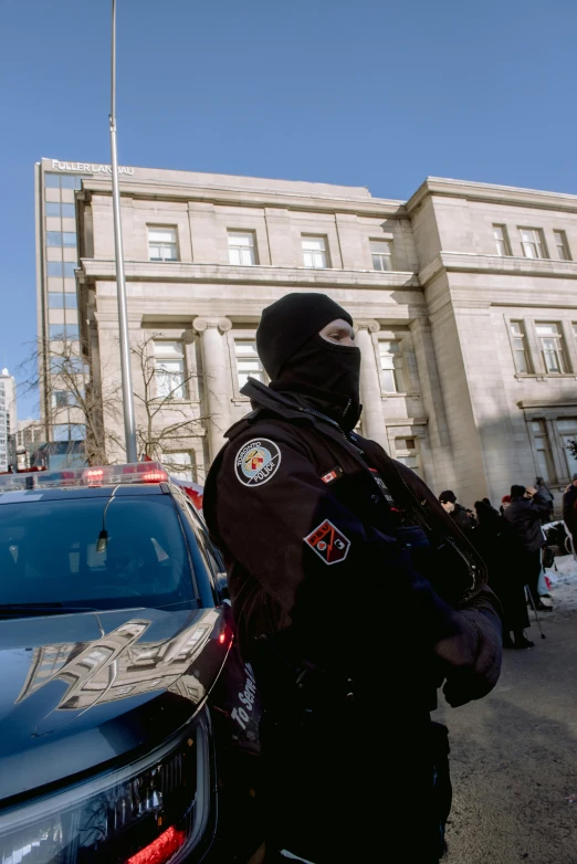 a group of police officers in line near some cars