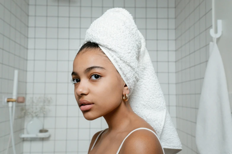 an african american woman posing in a toweled bathroom