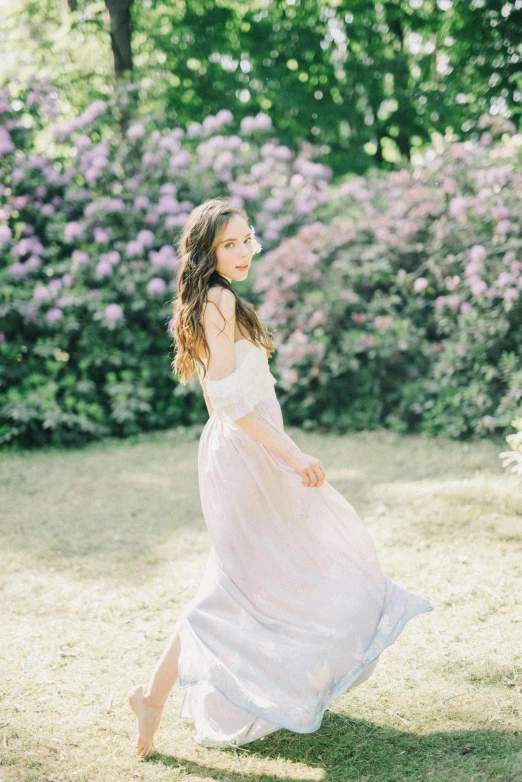 an adorable girl in a white dress on the grass