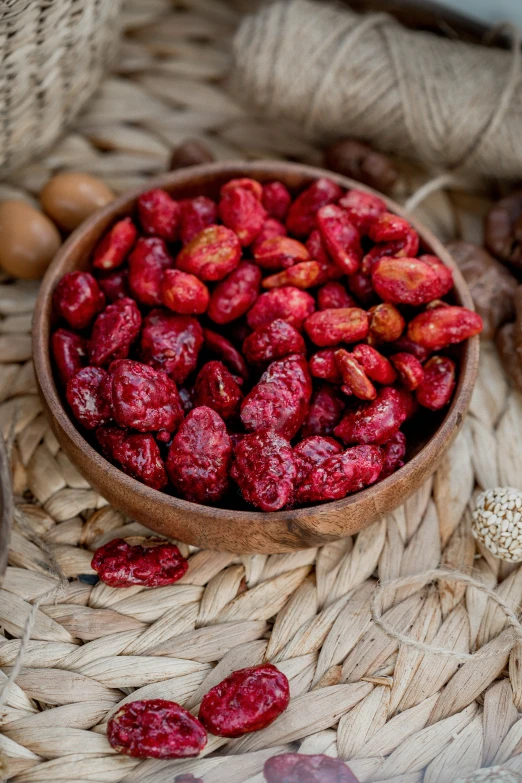 a small bowl of nuts sits on a cloth