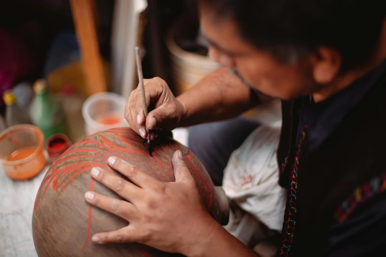 a woman making a vase with her hands