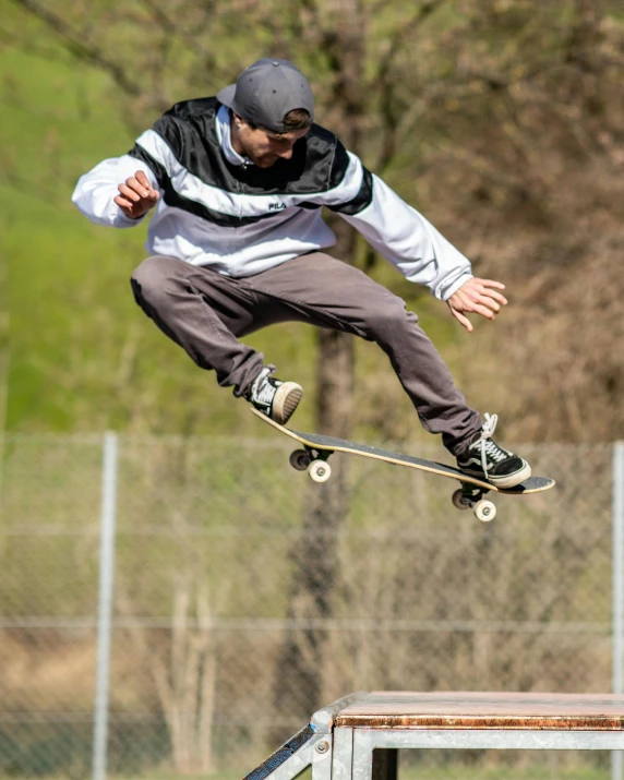 man in the air on skateboard next to metal structure