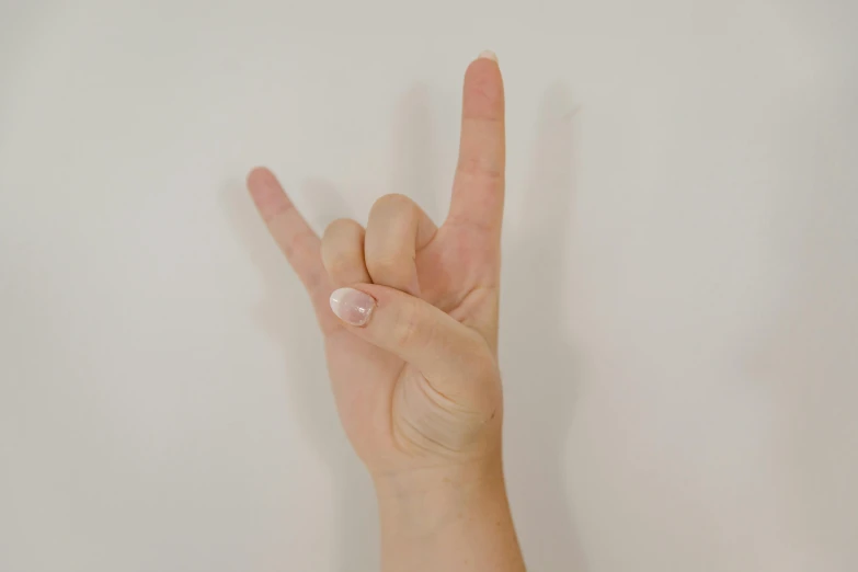 person making a peace sign with their fingers