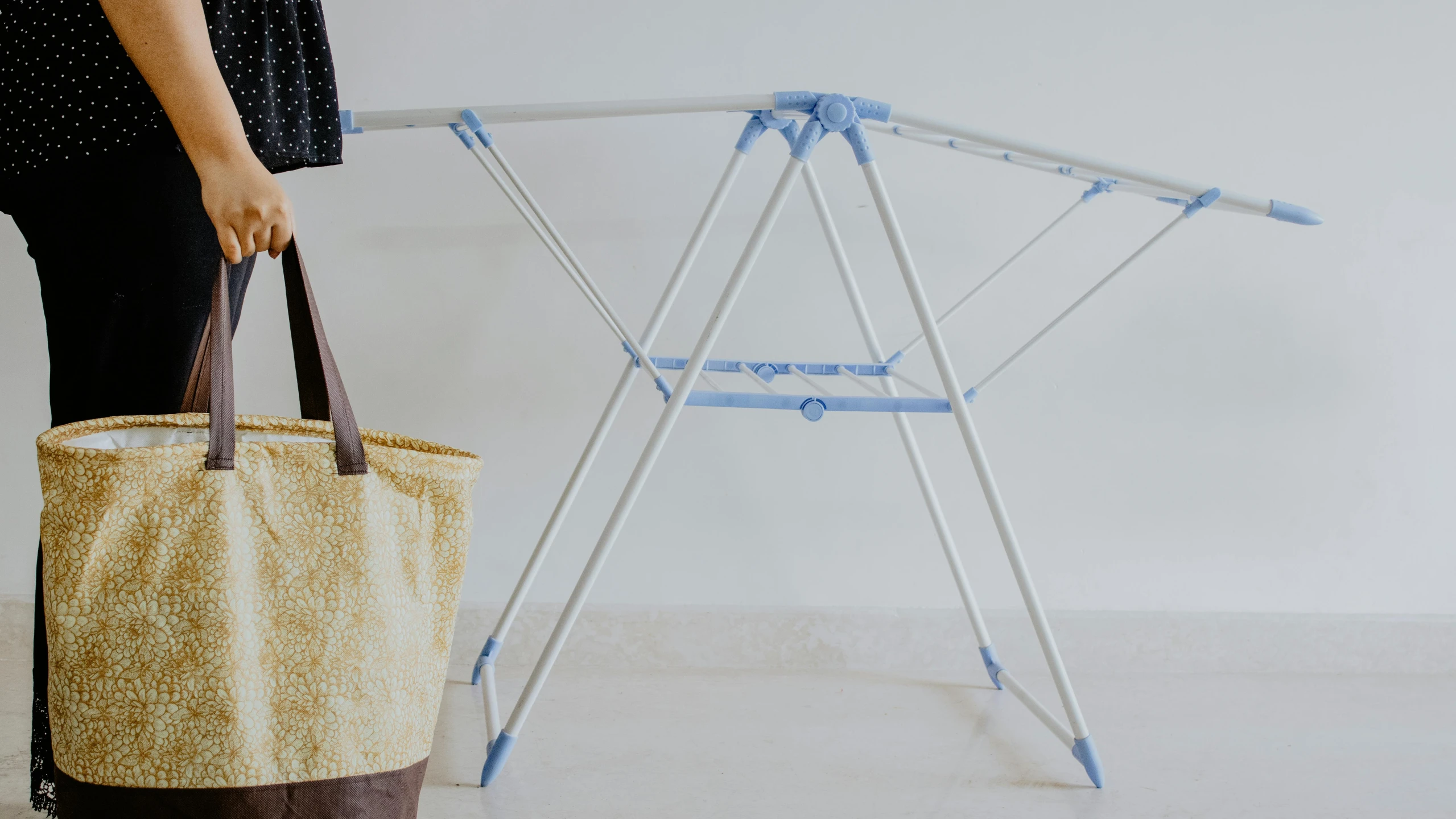 the handmade clothes rack and bag holder is set up to store clothing