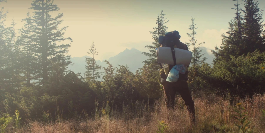 a man with a backpack in a field