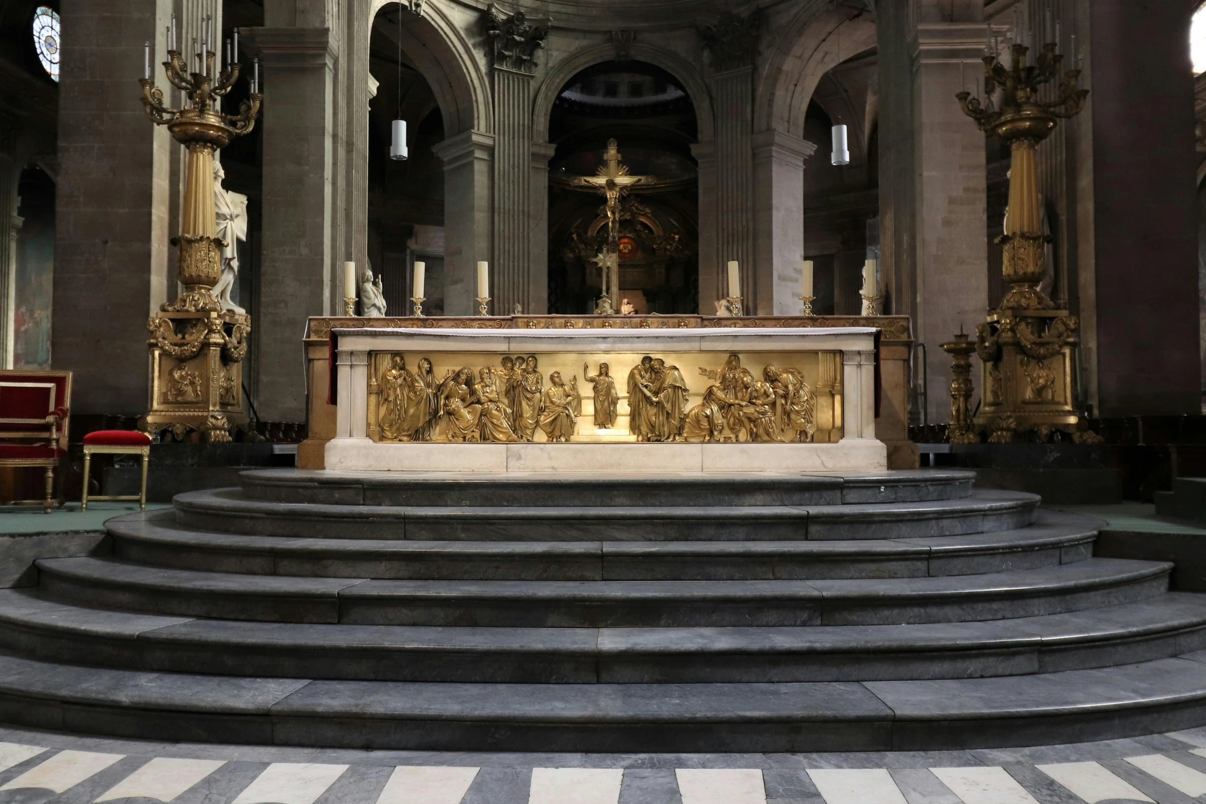 a picture of a church with pews and a statue