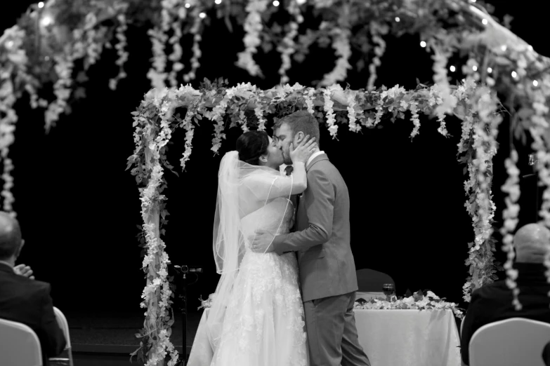 a man and woman posing for a picture together at their wedding ceremony