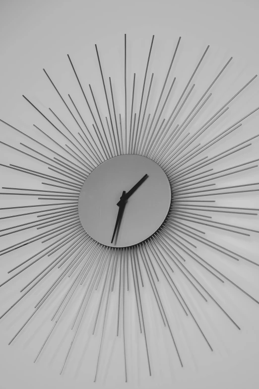 a clock that is connected with many large sticks