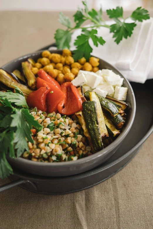 a bowl filled with grilled vegetables and other food