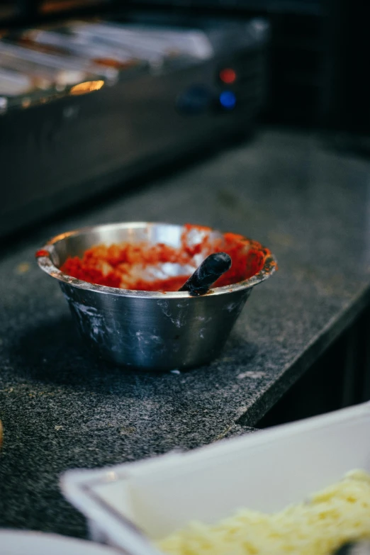 a silver bowl filled with food on top of a counter