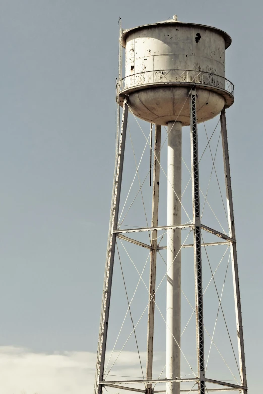 a large white water tower with two birds on the top