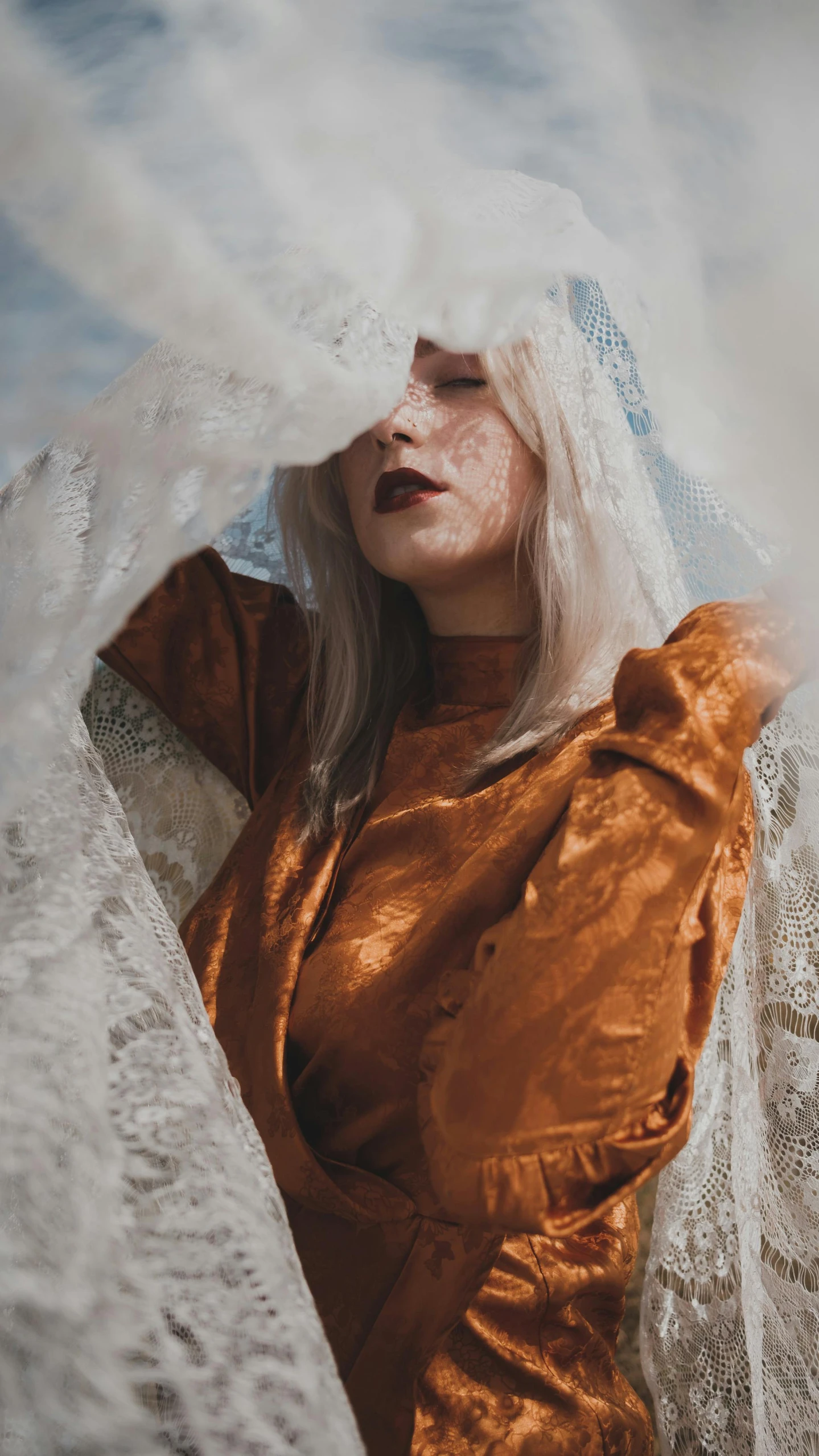 a woman is standing in a cloud like dress