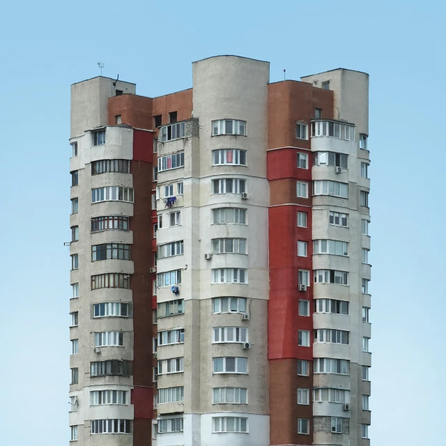 a bird flying in front of the windows of a tall building