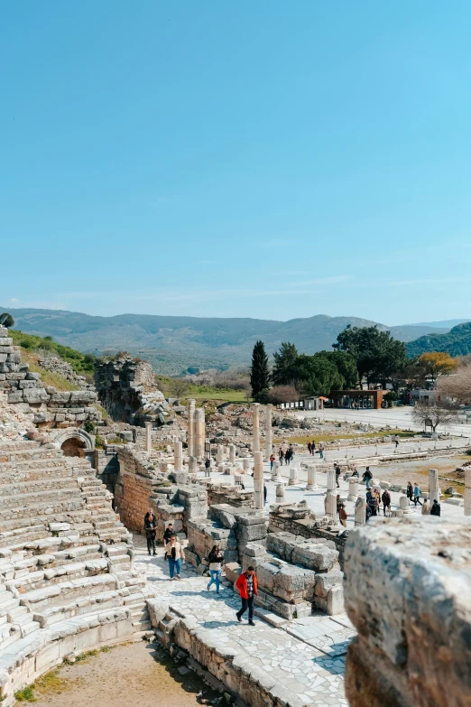 a stone structure with people walking around and on top of it