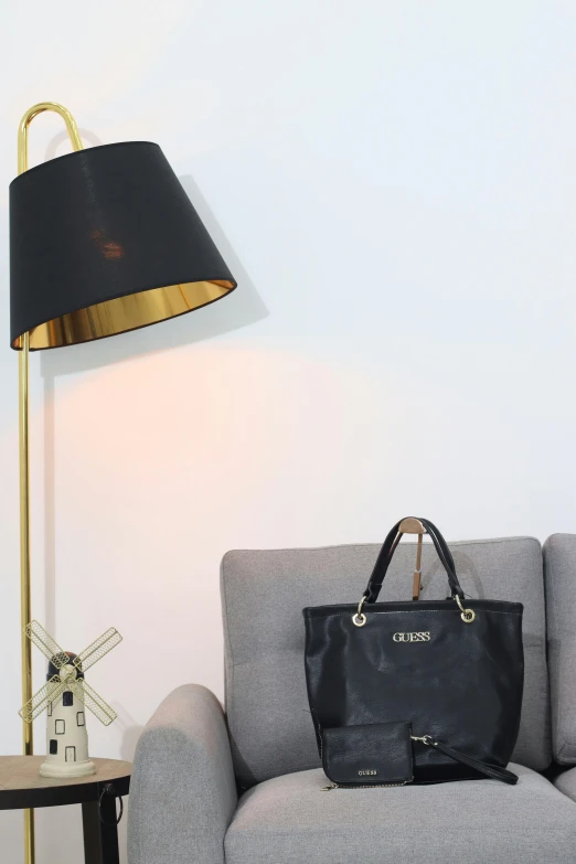 a black purse sitting on top of a couch