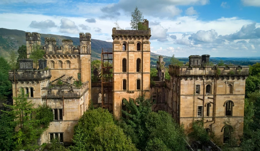 a castle that looks old and overgrown with trees