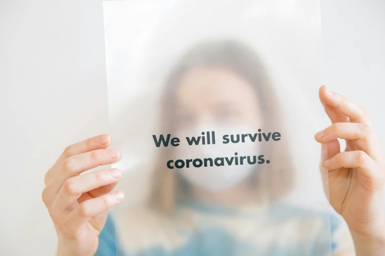 a woman holding a card with a message inside it