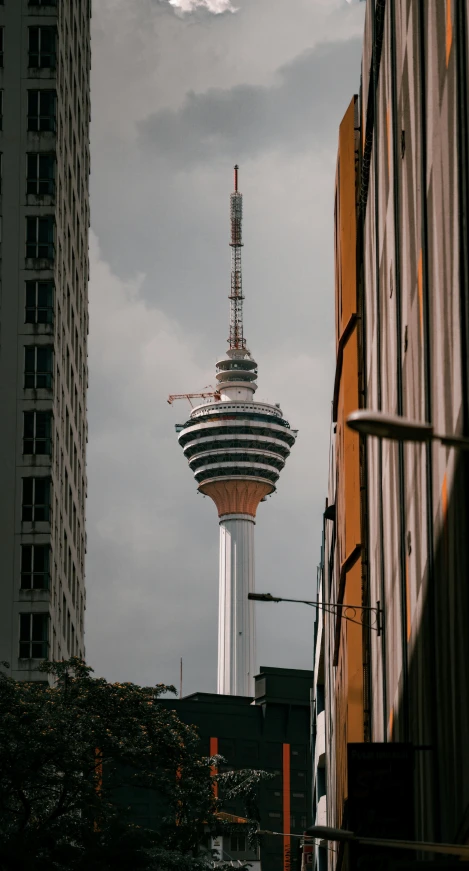 a tall white tower near tall buildings