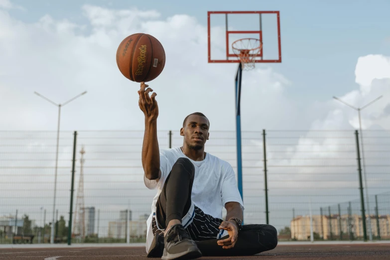 a young man is playing basketball in the court