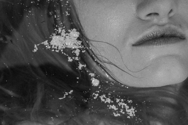 a close up of a person with snow flakes on their forehead