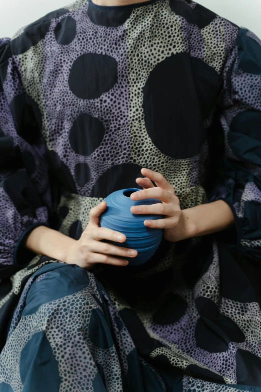 woman with blue bowl in foreground and hand wrapped around