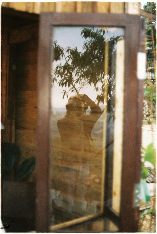 a woman taking a selfie in a large mirror