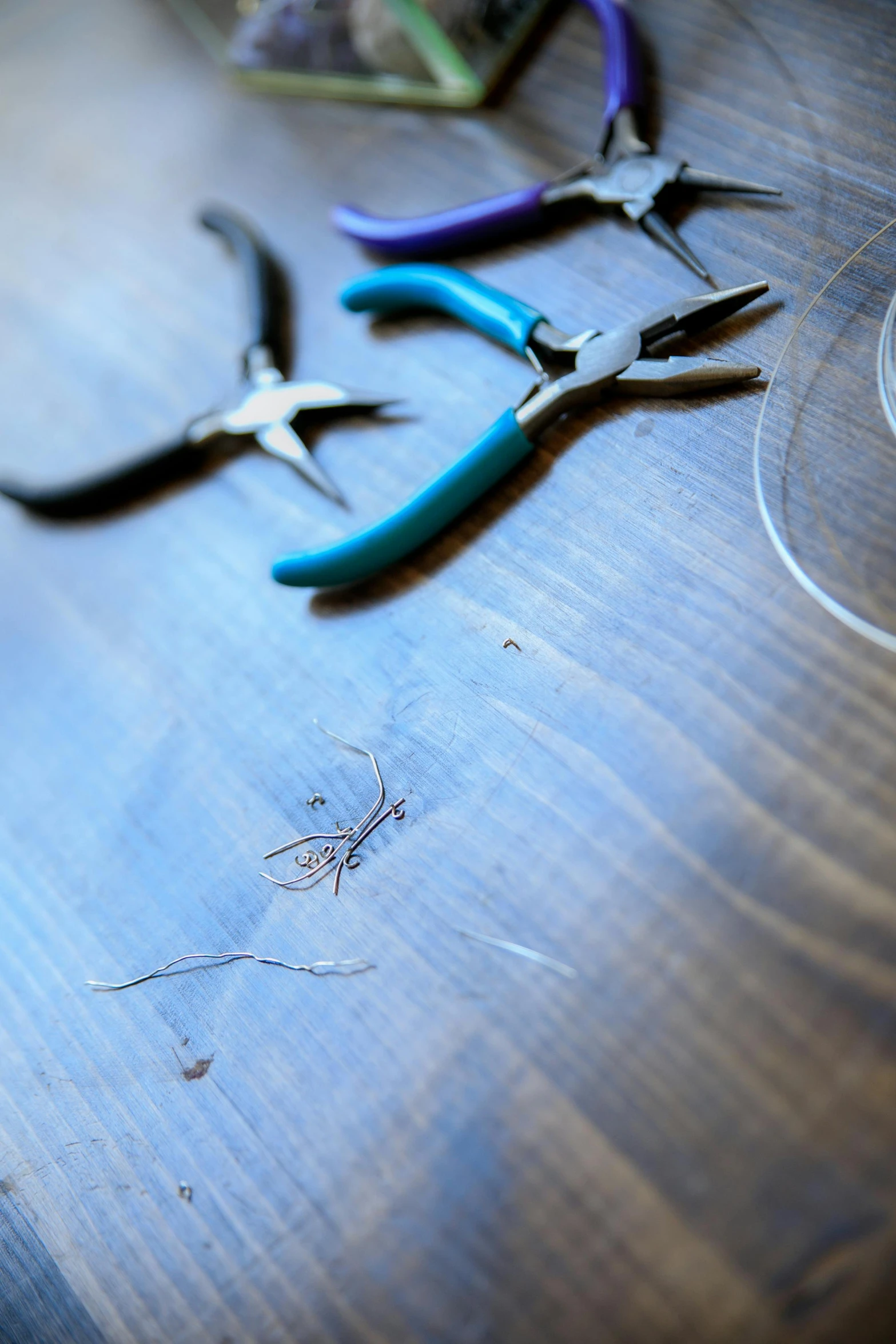 three pairs of scissors are sitting on a wooden surface