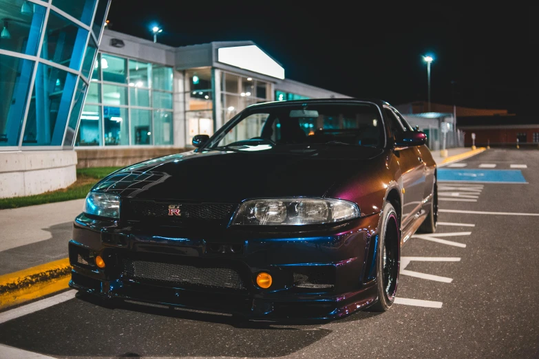 a car is parked outside a lit building