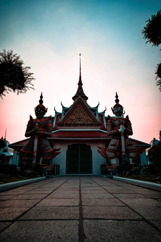 a building with large sculptures around the entrance