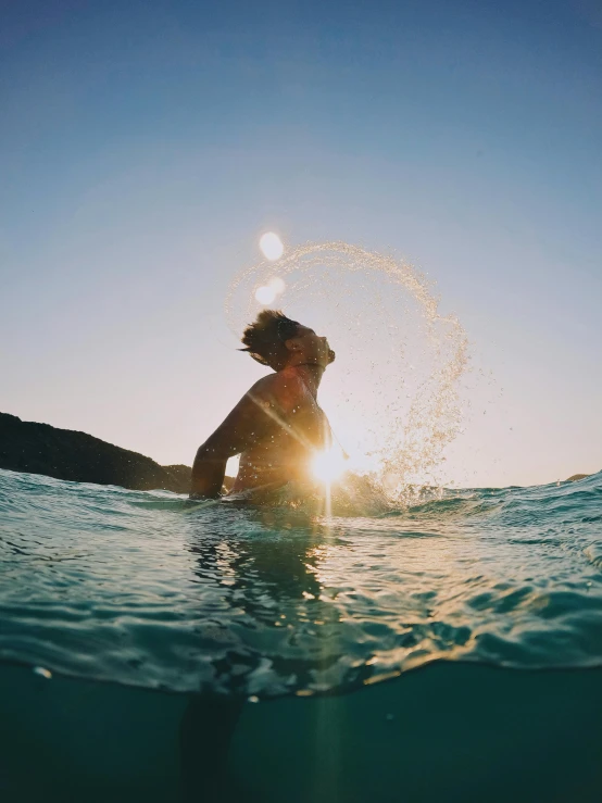 a person is sitting in the ocean water