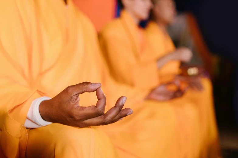 hands making peace sign in front of people