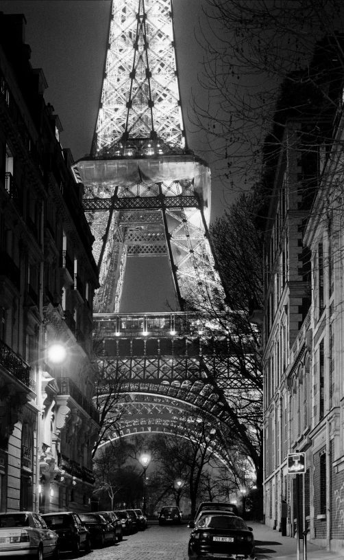 the eiffel tower lit up at night in black and white