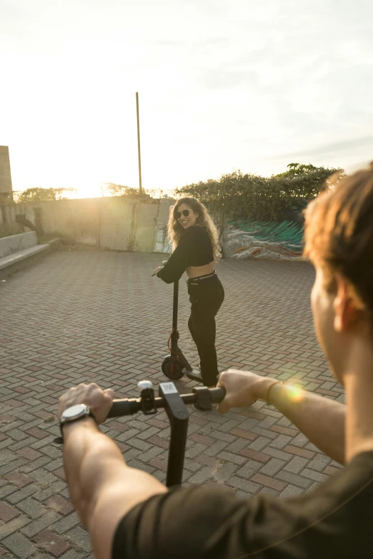 a person on a scooter with a lady in the background