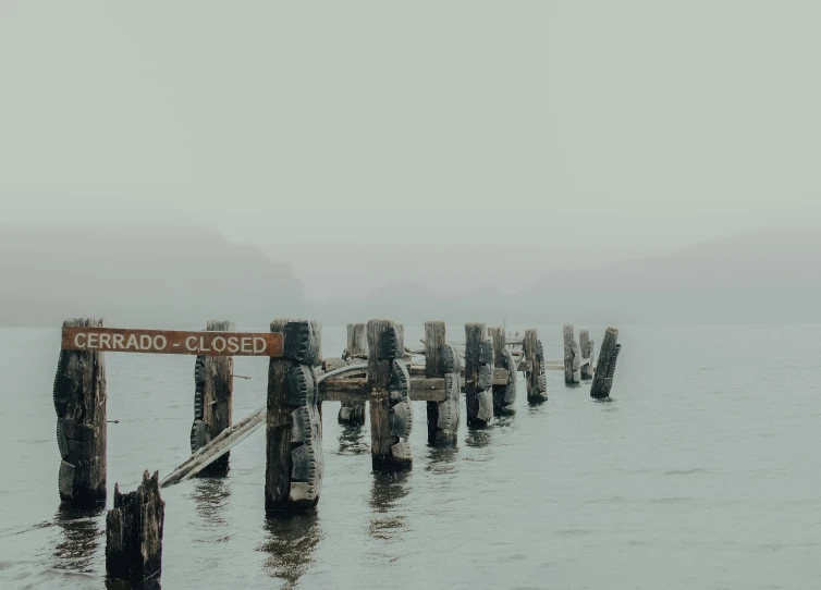 an old wooden dock has been knocked down with a sign that says cherred pier