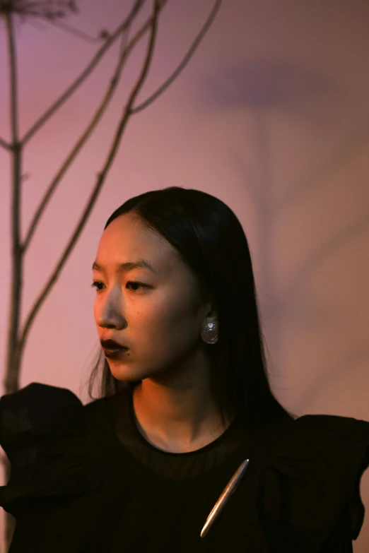 a woman looking intently at her cellphone in a dark environment