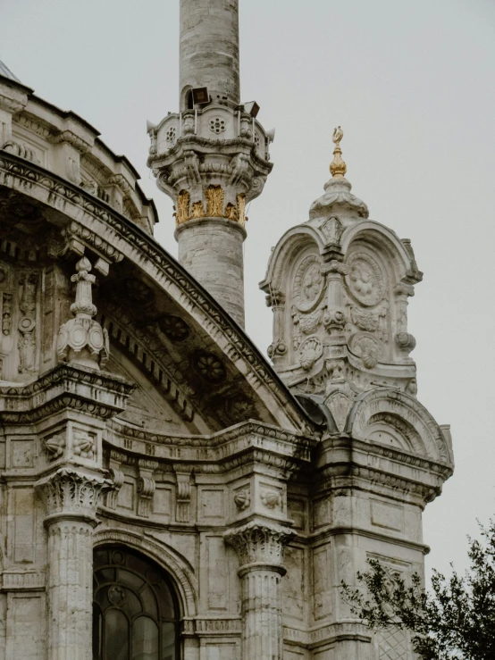 a very tall stone building with clocks in it