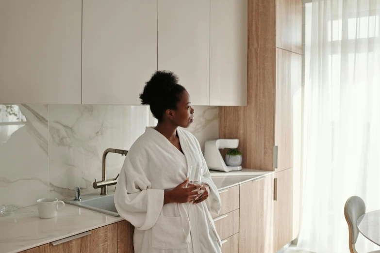 a woman standing in a bathroom with her arms crossed