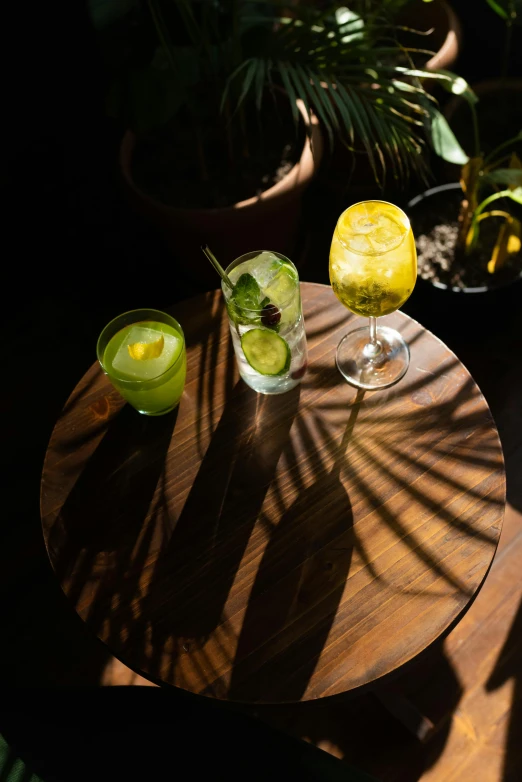 a table topped with two glasses filled with liquid